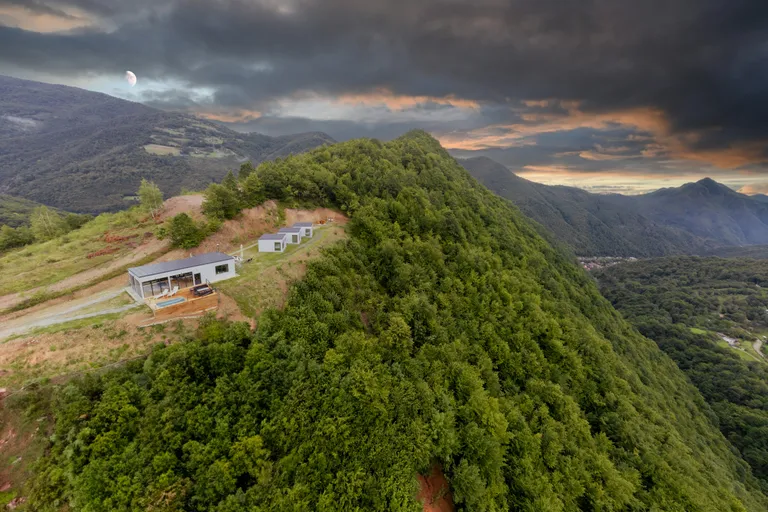 Mountain house above forested Carpathian ridges in Romania