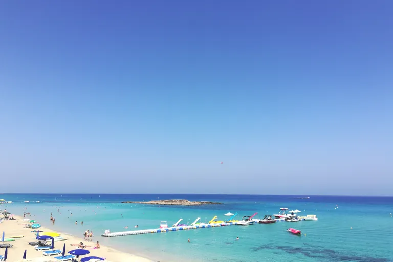 Clear turquoise water and pale sand at Fig Tree Beach in Cyprus