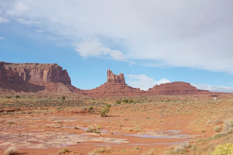 Red sandstone buttes and desert road in Valley of the Gods, Utah