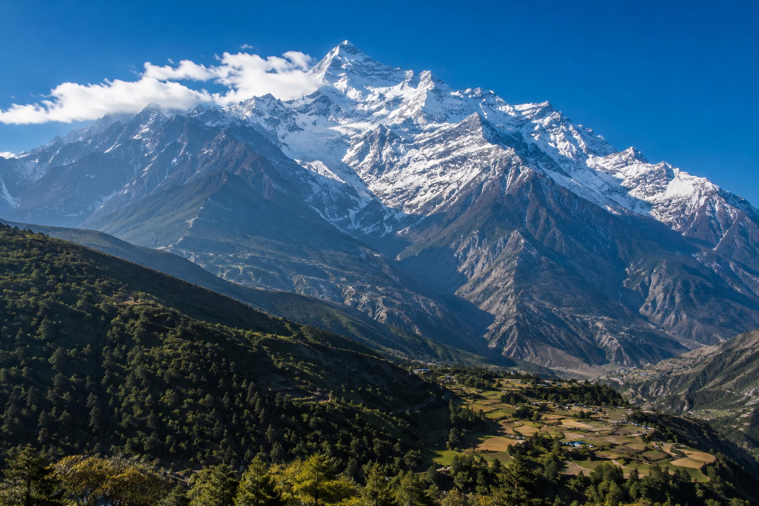 Snow-covered Annapurna peaks rising above a Himalayan valley in Nepal