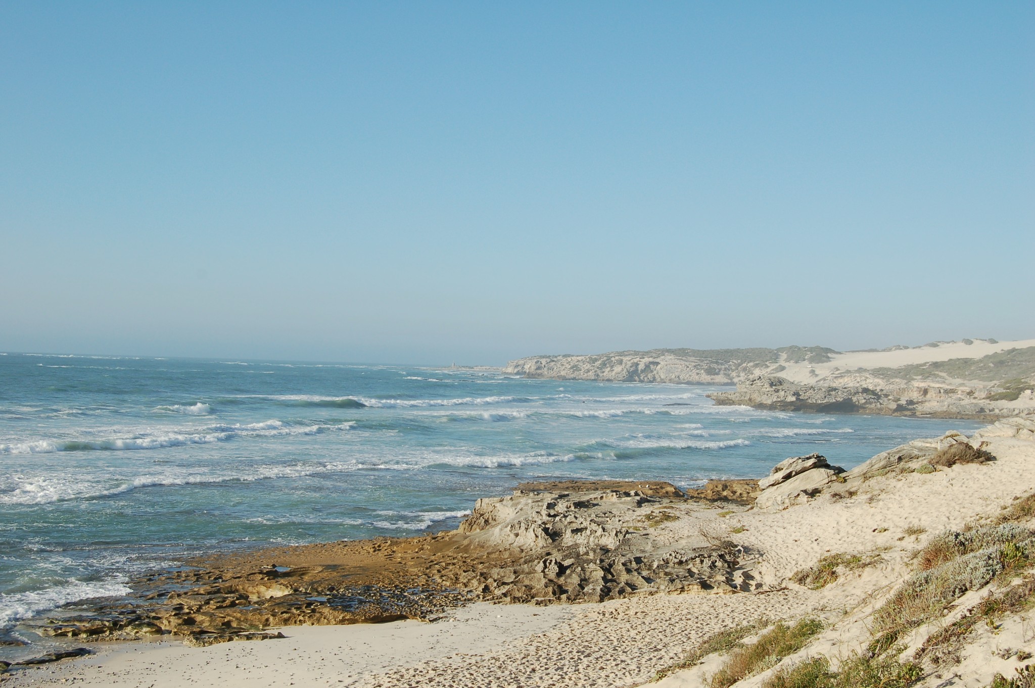White Arniston cottages under open coastal sky