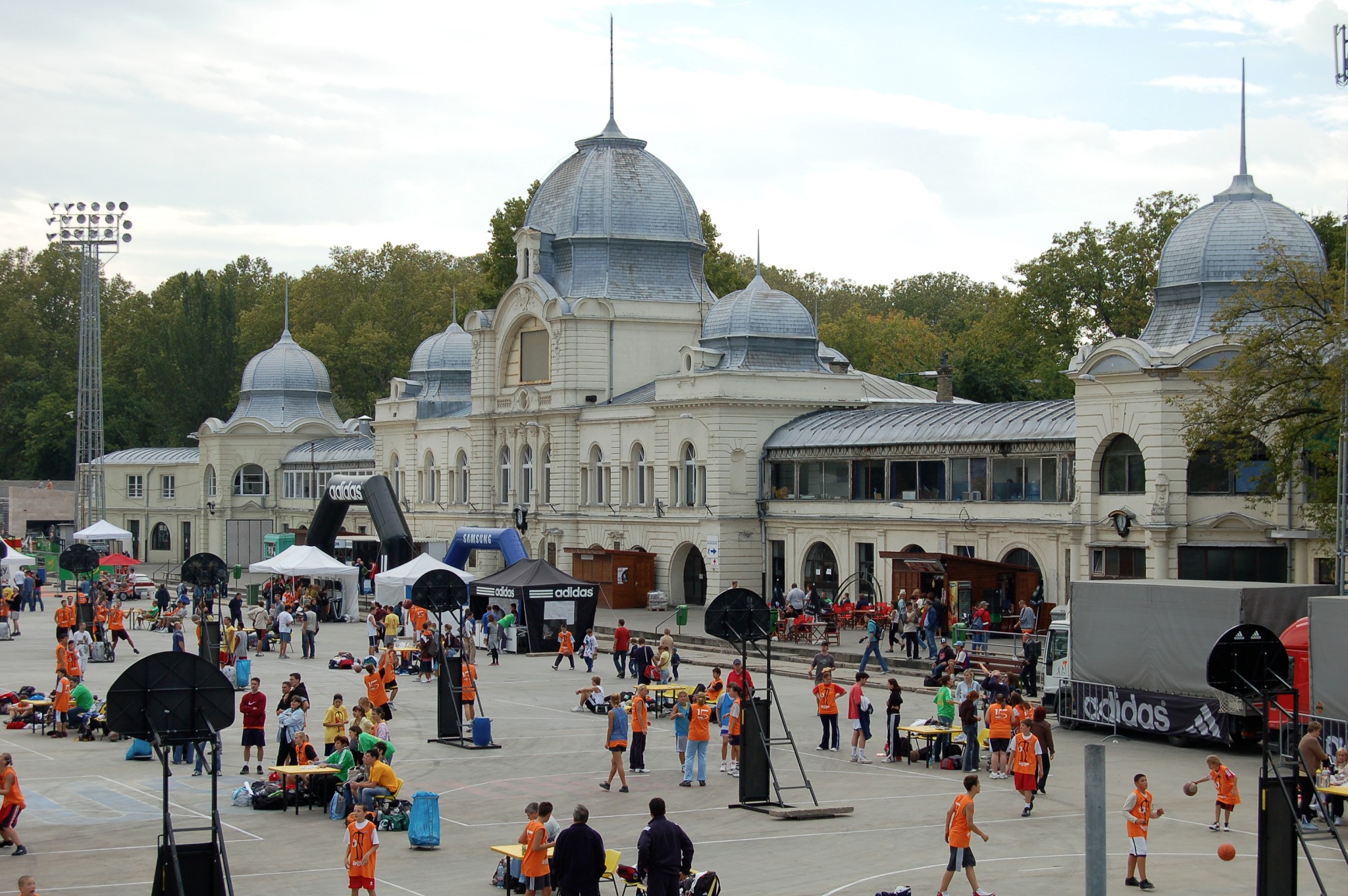 Historic domed thermal bath building in Budapest with people gathered outside