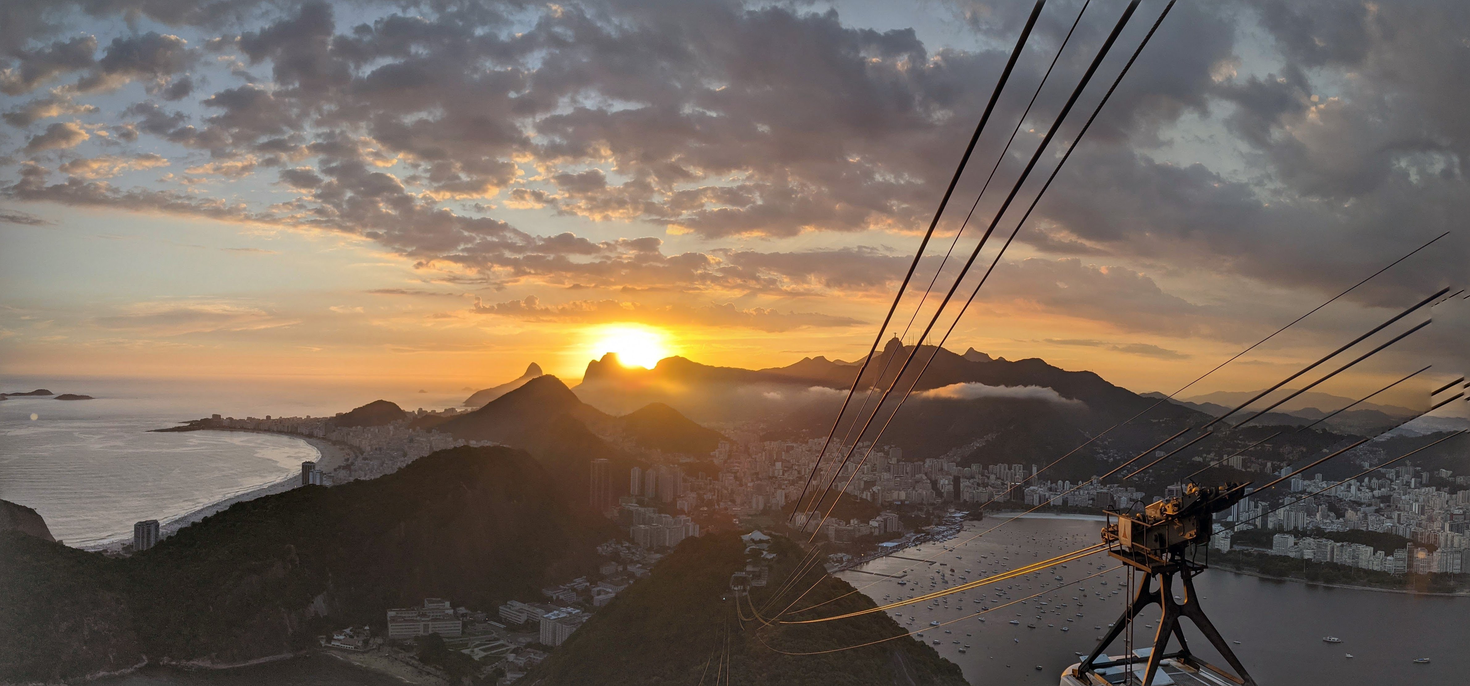 Sunset over Rio de Janeiro seen from the Sugarloaf cable car, with Copacabana beach and Botafogo bay below