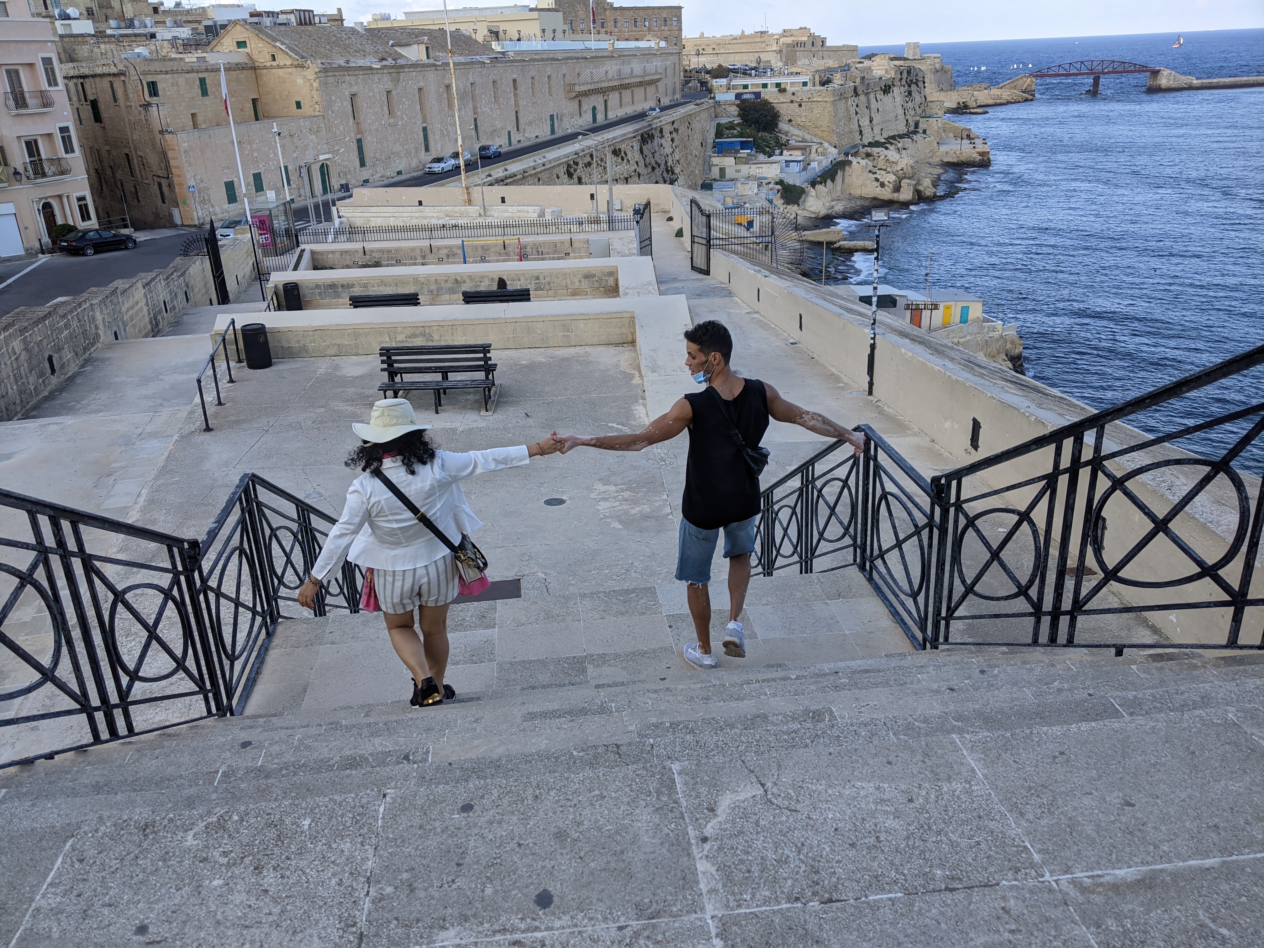 Stone steps descending toward the sea and fortifications in Malta