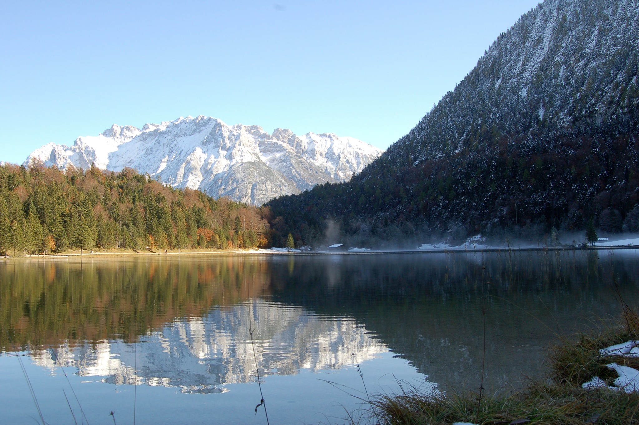 Mountain reflections and low mist over a lake near Mittenwald