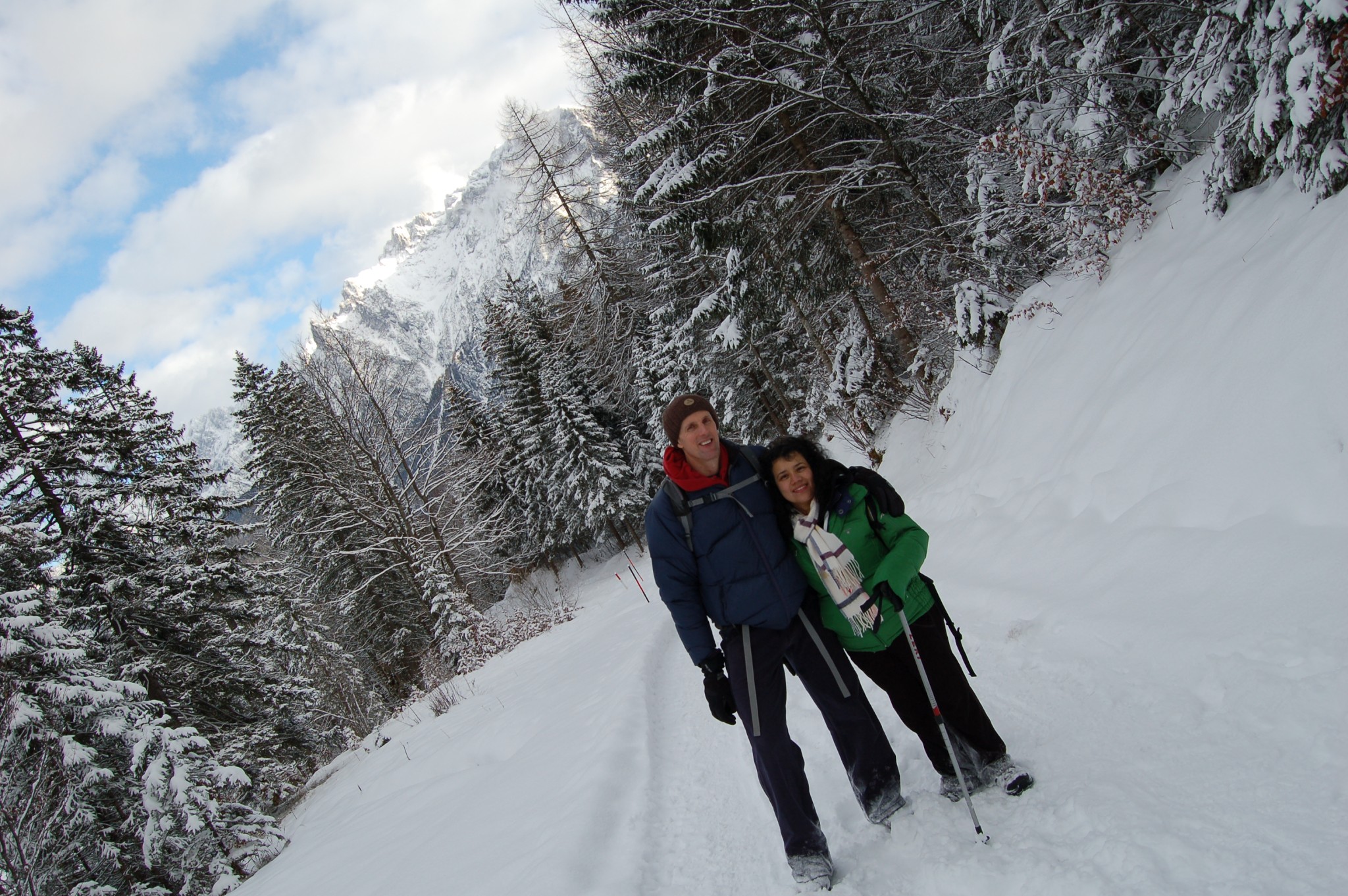 Winter walking trail through snowy forest near Mittenwald