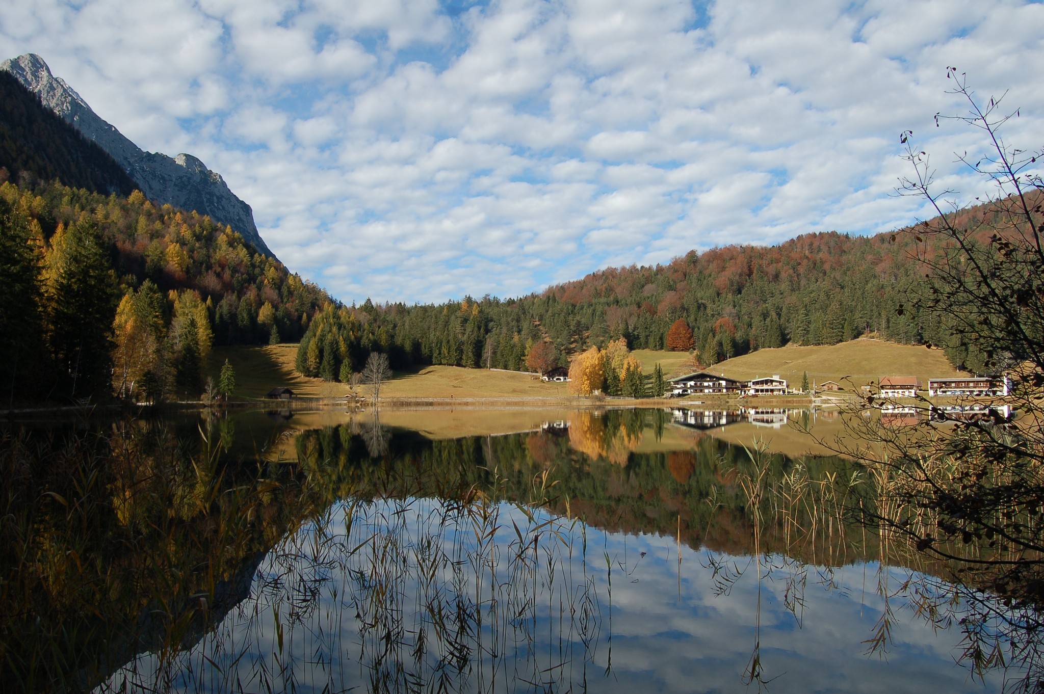 Autumn lake reflection with forest and mountains near Mittenwald